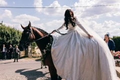 Bride riding a horse in her wedding dress