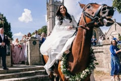 Bride leaving her church on her horse