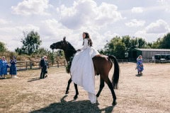Bride riding a horse in her wedding dress